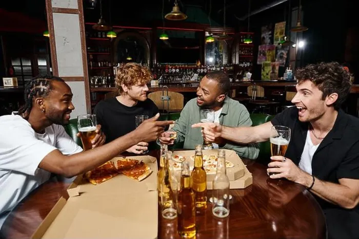 Framed Print : happy multiethnic friends joking, gesturing and chatting over pizza with beer, men on bachelor party Framed Print : happy multiethnic friends joking, gesturing and chatting over pizza with beer, men on bachelor party
