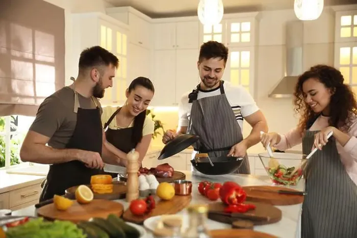 Framed Print : Happy people cooking food together in kitchen Framed Print : Happy people cooking food together in kitchen