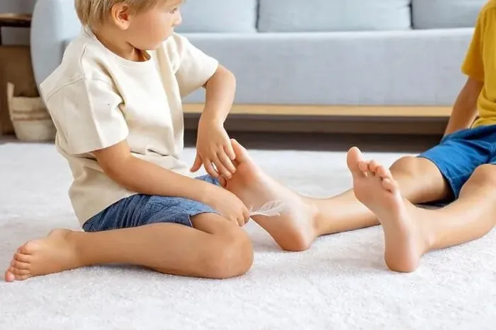 Framed Print : Happy positive children, tickling on the feet Framed Print : Happy positive children, tickling on the feet
