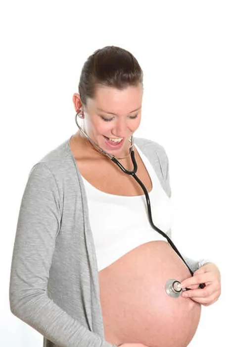 Framed Print : Happy, pregnant woman with stethoscope on belly Framed Print : Happy, pregnant woman with stethoscope on belly