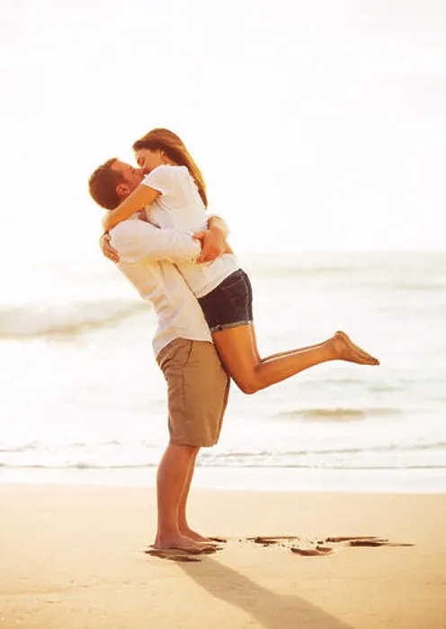 Framed Print : Happy Romantic Couple Kissing on the Beach at Sunset Framed Print : Happy Romantic Couple Kissing on the Beach at Sunset