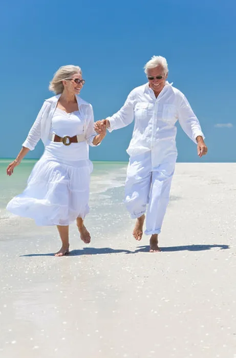 Framed Print : Happy senior man and woman couple running Framed Print : Happy senior man and woman couple running
