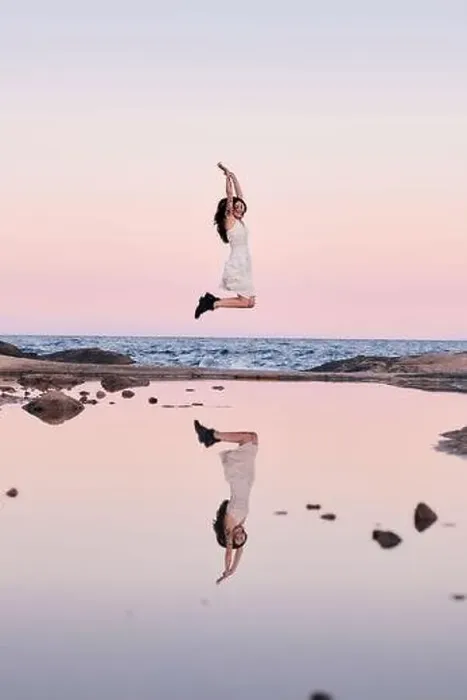 Framed Print : Happy woman jumping reflected in the water Framed Print : Happy woman jumping reflected in the water