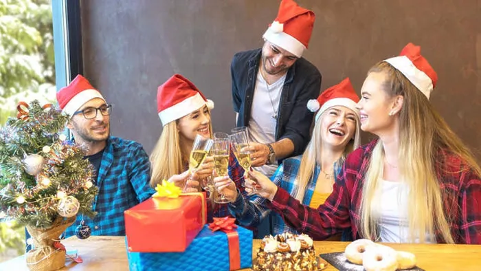 Framed Print : Happy young friends with santa hats celebrating Christmas toasting champagne at party Framed Print : Happy young friends with santa hats celebrating Christmas toasting champagne at party