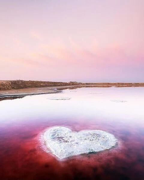 Heart from salt in pink water salt lake in Ukraine, Europe. Creative concept