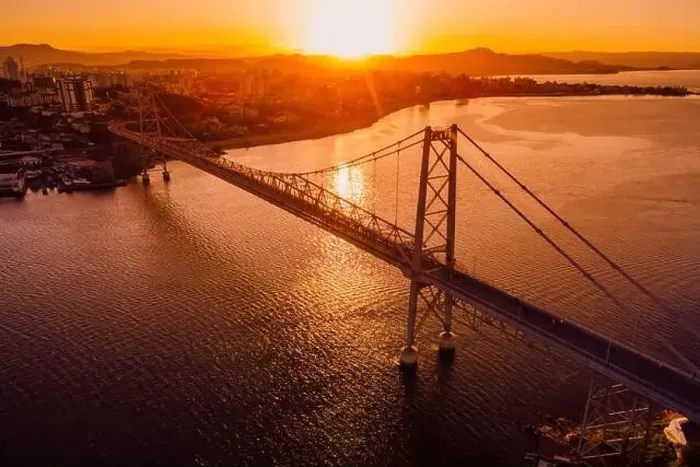 Framed Print : Hercilio luz bridge with warm sunset in Florianopolis, Brazil. Aerial view Framed Print : Hercilio luz bridge with warm sunset in Florianopolis, Brazil. Aerial view