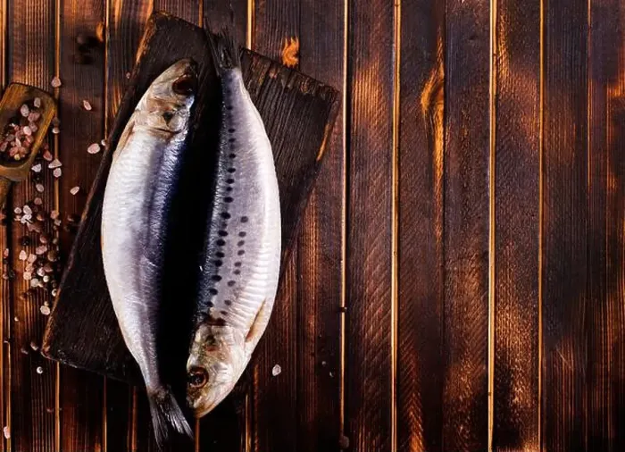 Framed Print : Herring or Baltic herring with salt on dark backgruond Framed Print : Herring or Baltic herring with salt on dark backgruond