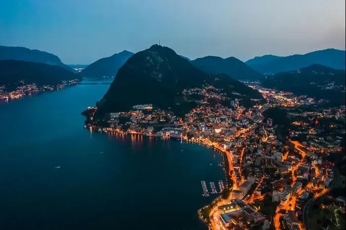Framed Print : High angle aerial drone night shot of city street lights by lake monte salvatore in Lugano, Switzerland