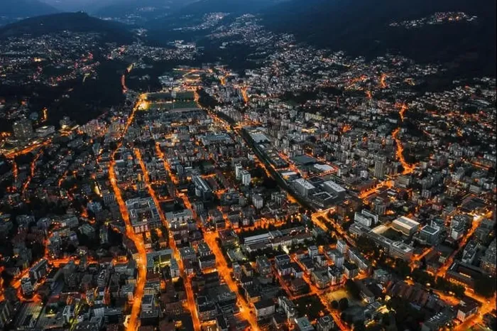 Framed Print : High angle aerial drone night shot of city street lights in Lugano, Switzerland Framed Print : High angle aerial drone night shot of city street lights in Lugano, Switzerland