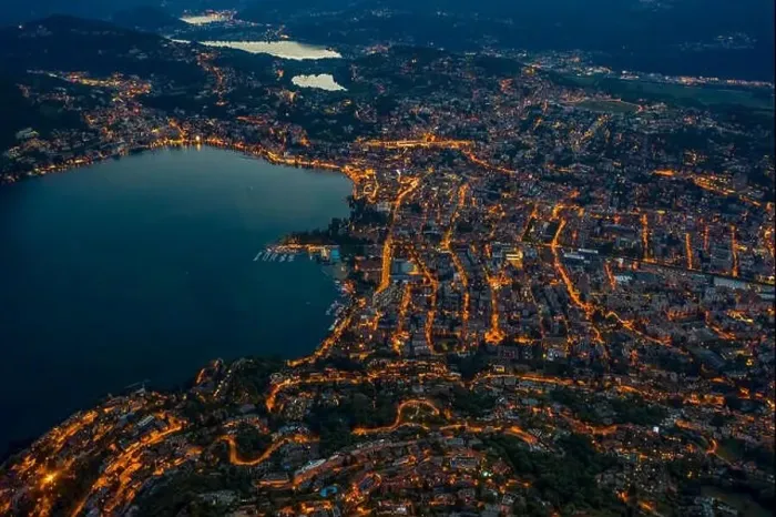Framed Print : High angle aerial drone shot view Lugano by lake with city street lights after sunset in Switzerland Framed Print : High angle aerial drone shot view Lugano by lake with city street lights after sunset in Switzerland