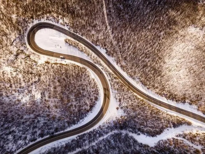 Framed Print : High angle aerial view drone image on the curved serpentine road trough the trees Framed Print : High angle aerial view drone image on the curved serpentine road trough the trees
