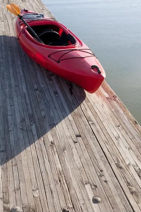 Framed Print : High angle view of kayak and paddle on wooden pier next to water Framed Print : High angle view of kayak and paddle on wooden pier next to water