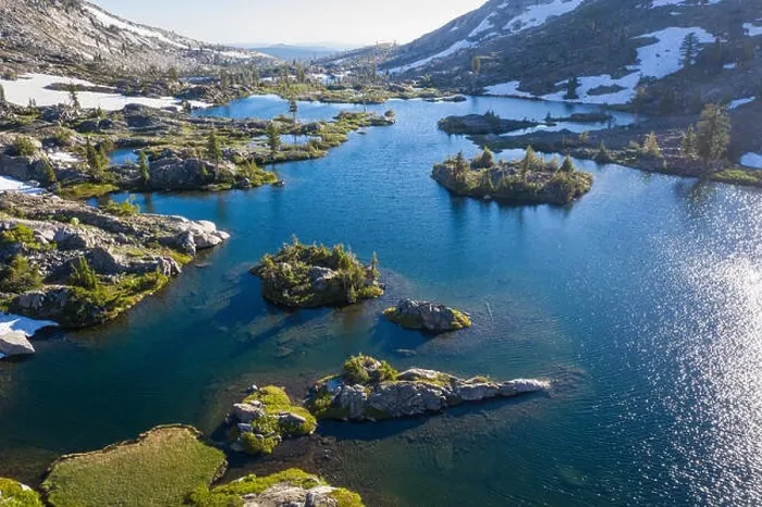 Framed Print : High granite mountains surround a beautiful lake in the Desolation Wilderness, California. This mountainous area is a popular backpacking destination Framed Print : High granite mountains surround a beautiful lake in the Desolation Wilderness, California. This mountainous area is a popular backpacking destination