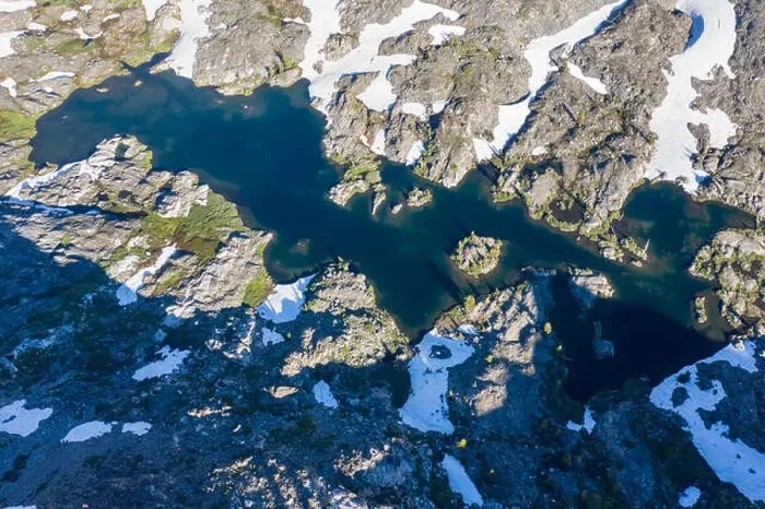 Framed Print : High granite mountains surround a beautiful lake in the Desolation Wilderness, California. This mountainous area is a popular backpacking destination Framed Print : High granite mountains surround a beautiful lake in the Desolation Wilderness, California. This mountainous area is a popular backpacking destination