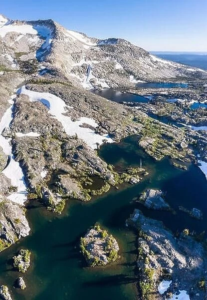 High granite mountains surround beautiful lakes in the Desolation Wilderness, California. This mountainous area is a popular backpacking destination