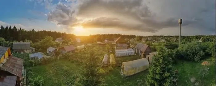 Framed Print : High View from the height of a flying drone, a small village with houses and cottages, green fields on a summer day