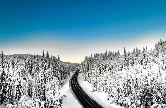 Framed Print : Highway with cars driving through a mountain pass with snow covered trees Framed Print : Highway with cars driving through a mountain pass with snow covered trees
