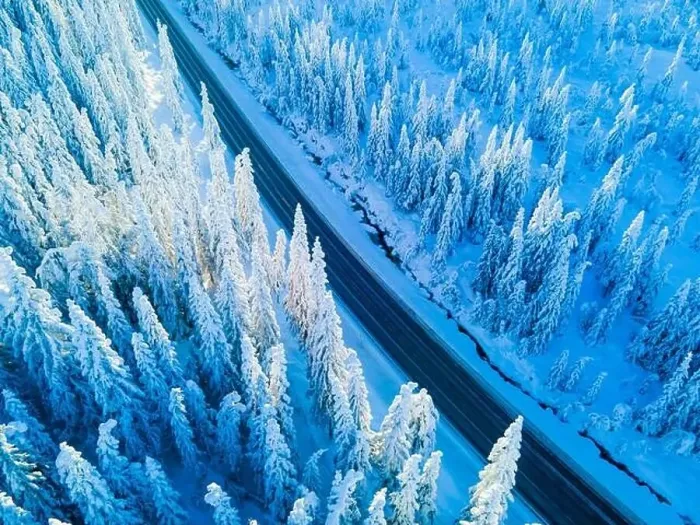 Framed Print : Highway through a mountain pass with snow covered trees Framed Print : Highway through a mountain pass with snow covered trees