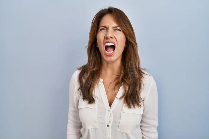 Framed Print : Hispanic woman standing over isolated background angry and mad screaming frustrated and furious Framed Print : Hispanic woman standing over isolated background angry and mad screaming frustrated and furious
