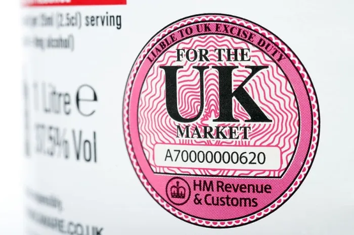 Framed Print : HM Revenue & Customs liable to UK excise duty label printed on a bottle of Vodka