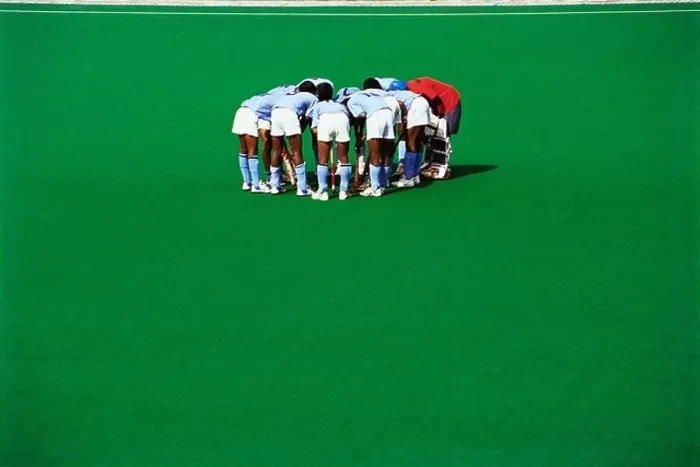 Framed Print : Hockey players conference huddle on green astro turf ground