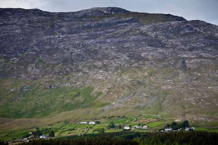 Framed Print : Homes nestling at the foot of the Maumturk mountain range near Recess in Connemara, County Galway, Ireland