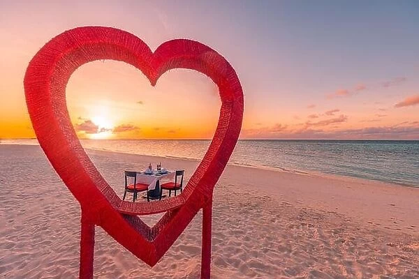 Honeymoon couples dinner at private luxury romantic dinner on tropical beach in Maldives. Seaside sea view, amazing island shore with red heart shape