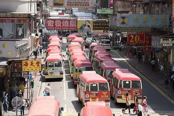 Hong Kong, China - August 14, 2017: Minibuses lining up, waiting for passengers at a busy station in Mongkok, Hong Kong, China