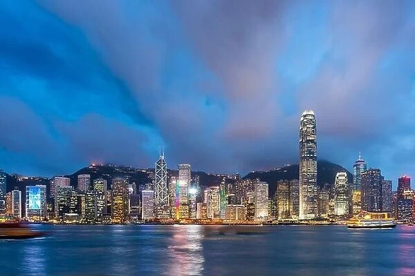 Hong Kong, China downtown cityscape from the harbor at dusk