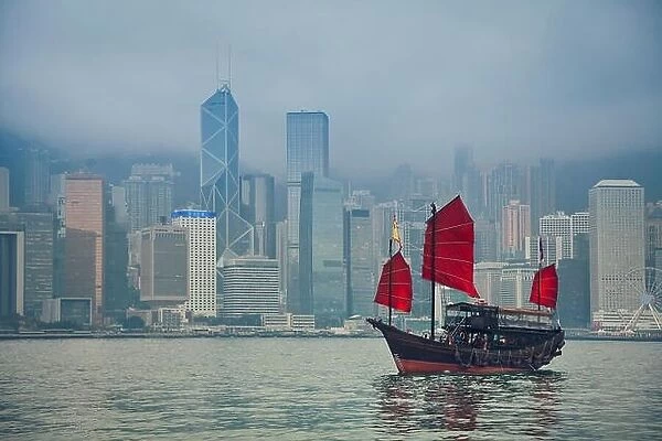 Hong Kong, China. Hong Kong Junkboat sailing along Hong Kong Skyline on a foggy day