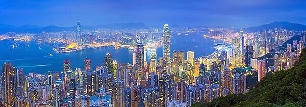 Hong Kong Panorama. Panoramic image of Hong Kong with many skyscrapers during twilight blue hour