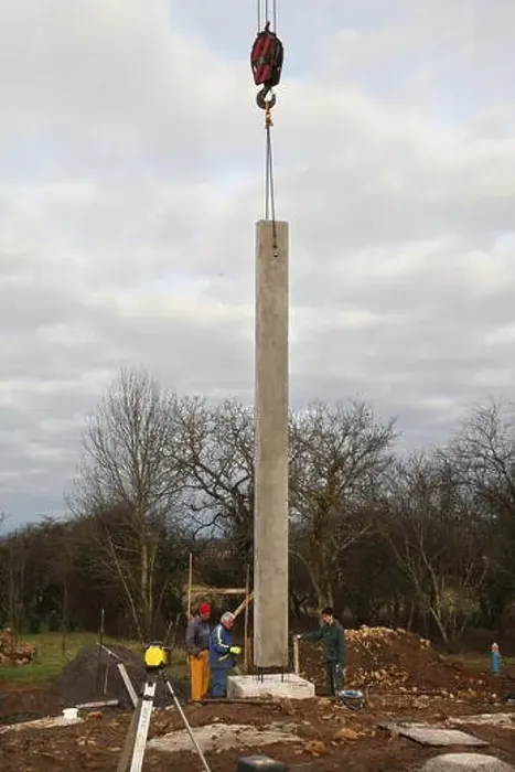 Framed Print : House building, installation of a concrete post on a concrete footing for a house's foundations Framed Print : House building, installation of a concrete post on a concrete footing for a house's foundations