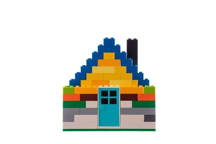 Framed Print : House made of classic building blocks and bricks, white studio background Framed Print : House made of classic building blocks and bricks, white studio background