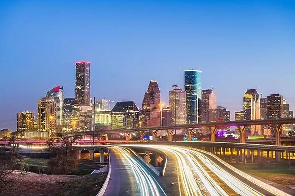 Houston, Texas, USA downtown city skyline and highway at dusk