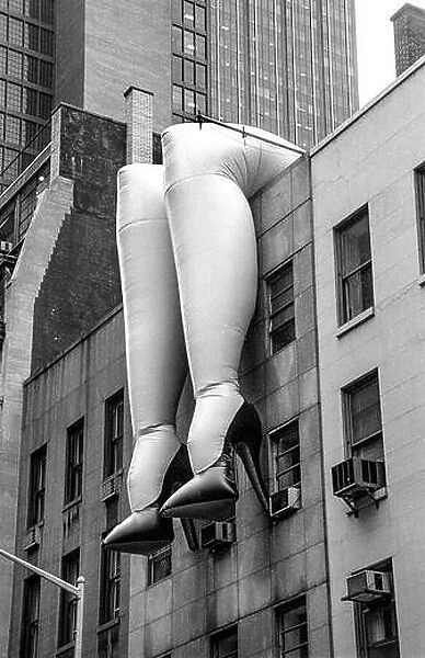 A huge pair of inflated female legs on a building in midtown Manhattan advertise an exhibition at the nearby Museum of Modern Art