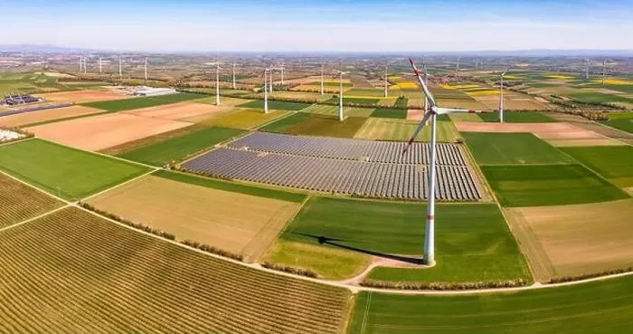 Framed Print : Huge wind turbines between agricultural land and a solar park in a rural area from a drone view, Germany Framed Print : Huge wind turbines between agricultural land and a solar park in a rural area from a drone view, Germany