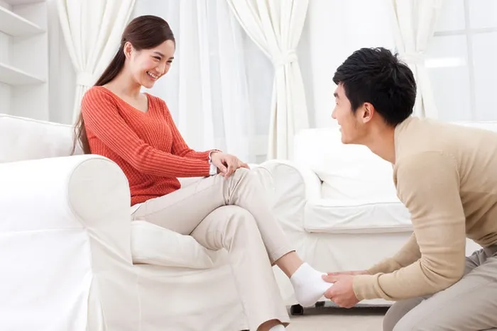 Framed Print : Husband doing foot message for his wife