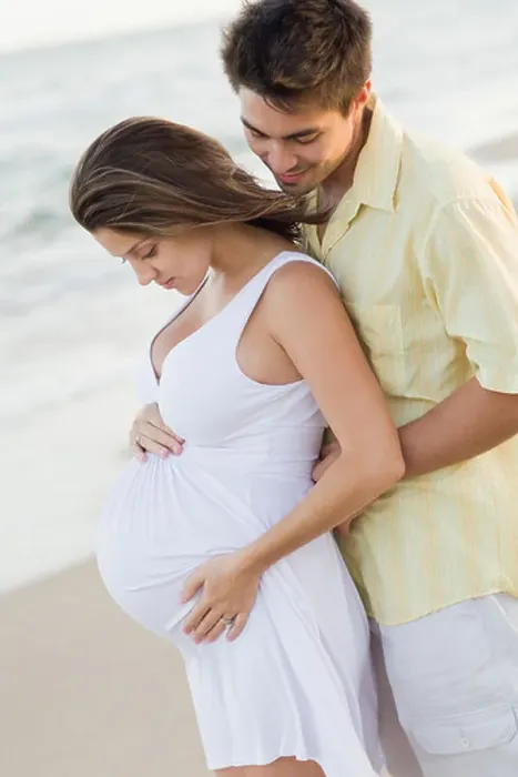 Framed Print : Husband hugging pregnant wife on beach Framed Print : Husband hugging pregnant wife on beach