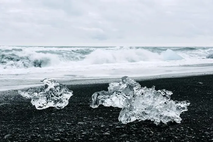 Framed Print : Iceberg pieces on black Diamond beach near Jokulsarlon lagoon, Iceland. Atlantic ocean waves and cloudy sky on background. Landscape photography Framed Print : Iceberg pieces on black Diamond beach near Jokulsarlon lagoon, Iceland. Atlantic ocean waves and cloudy sky on background. Landscape photography