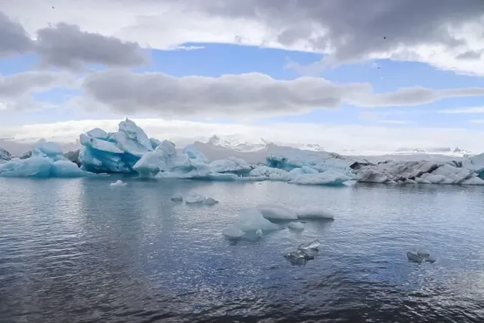 Framed Print : Icebergs are floating in jokulsarlon glacier lagoon in iceland, creating a breathtaking view under a cloudy sky