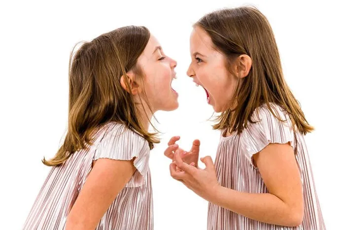 Framed Print : Identical twin girls sisters are arguing yelling at each other. Angry girls are shouting, yelling and arguing with emotional expression on faces. Fron Framed Print : Identical twin girls sisters are arguing yelling at each other. Angry girls are shouting, yelling and arguing with emotional expression on faces. Fron