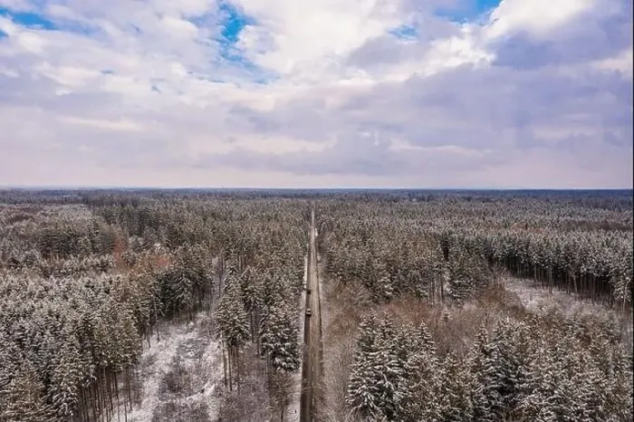 Framed Print : Idyllic winter panorama from an aerial view with a snow-covered forest and a to the horizon leading road Framed Print : Idyllic winter panorama from an aerial view with a snow-covered forest and a to the horizon leading road