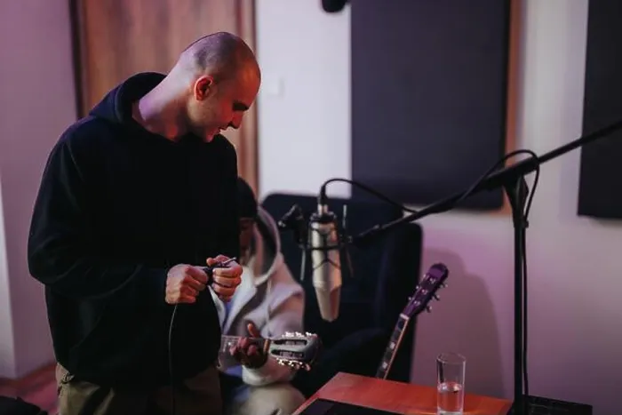 Framed Print : The image captures a musician and a producer working together in a modern recording studio Framed Print : The image captures a musician and a producer working together in a modern recording studio