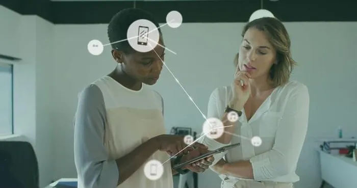 Framed Print : Image of connected icons over diverse female coworkers discussing reports on digital tablet