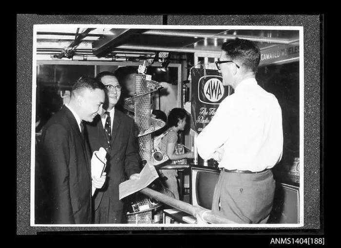 Framed Print : This image shows two men examining a display by the AWA (Amalgamated Wireless Australia) company on board a trade ship Framed Print : This image shows two men examining a display by the AWA (Amalgamated Wireless Australia) company on board a trade ship