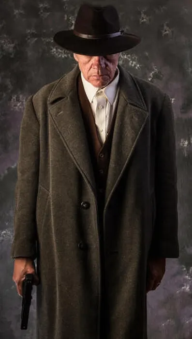 Framed Print : Image of sinister looking man wearing overcoat and hat holding automatic pistol to one side against portrait background Framed Print : Image of sinister looking man wearing overcoat and hat holding automatic pistol to one side against portrait background