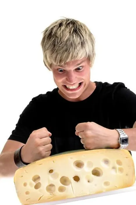 Framed Print : In-your-face guy: young man pounding on a cheese wheel