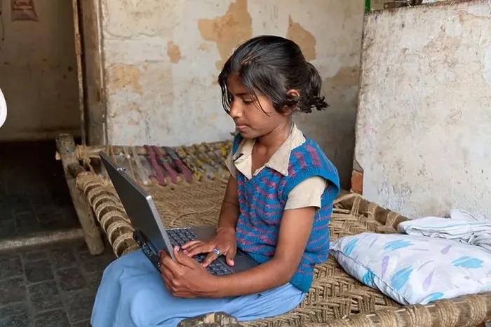 Framed Print : India, uttar Pradesh, Agra Serious pre-teenage girl using laptop whilst sitting on bed Framed Print : India, uttar Pradesh, Agra Serious pre-teenage girl using laptop whilst sitting on bed