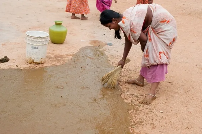 Framed Print : Indian custom of a woman spreading watered down cow dung outside the front of her home. Andhra Pradesh, India Framed Print : Indian custom of a woman spreading watered down cow dung outside the front of her home. Andhra Pradesh, India