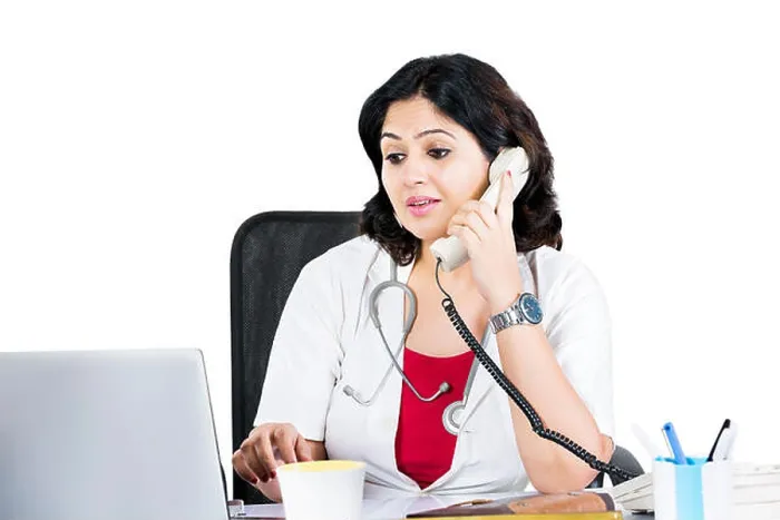 Framed Print : Indian Female Doctor Using Laptop And Talking Telephone Framed Print : Indian Female Doctor Using Laptop And Talking Telephone